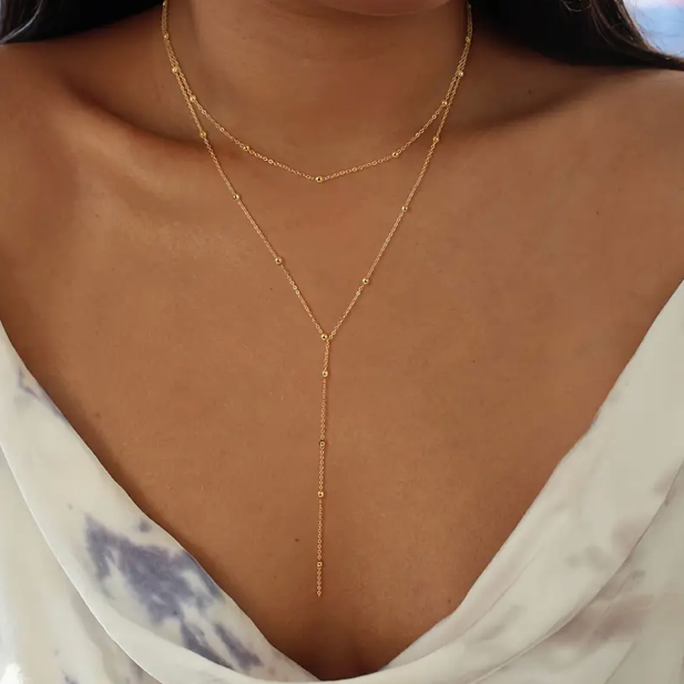 Double layer necklace with geometric beads and tassels